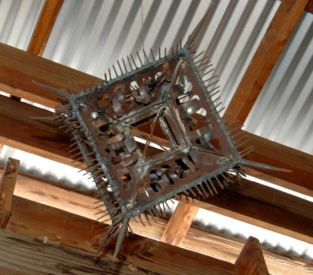A heavily articulated steel cube with many welded elements