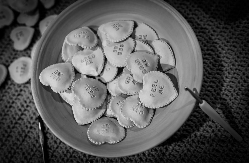 a bowl of ceramic-ravioli-candy-hearts by Claudia Solorzano