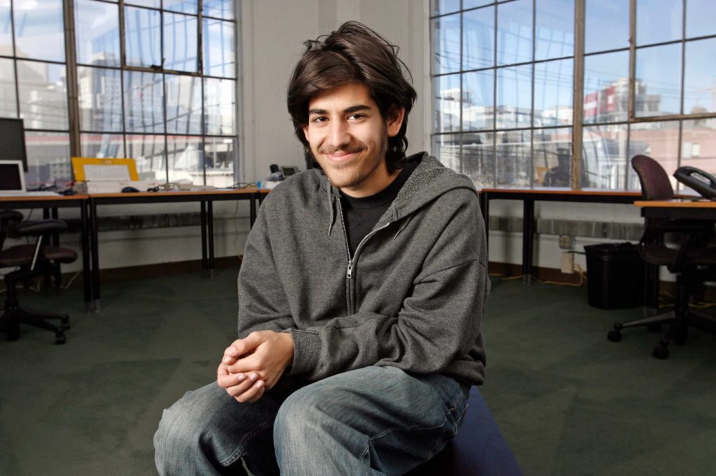 Aaron Swartz sitting in the center of a large office
