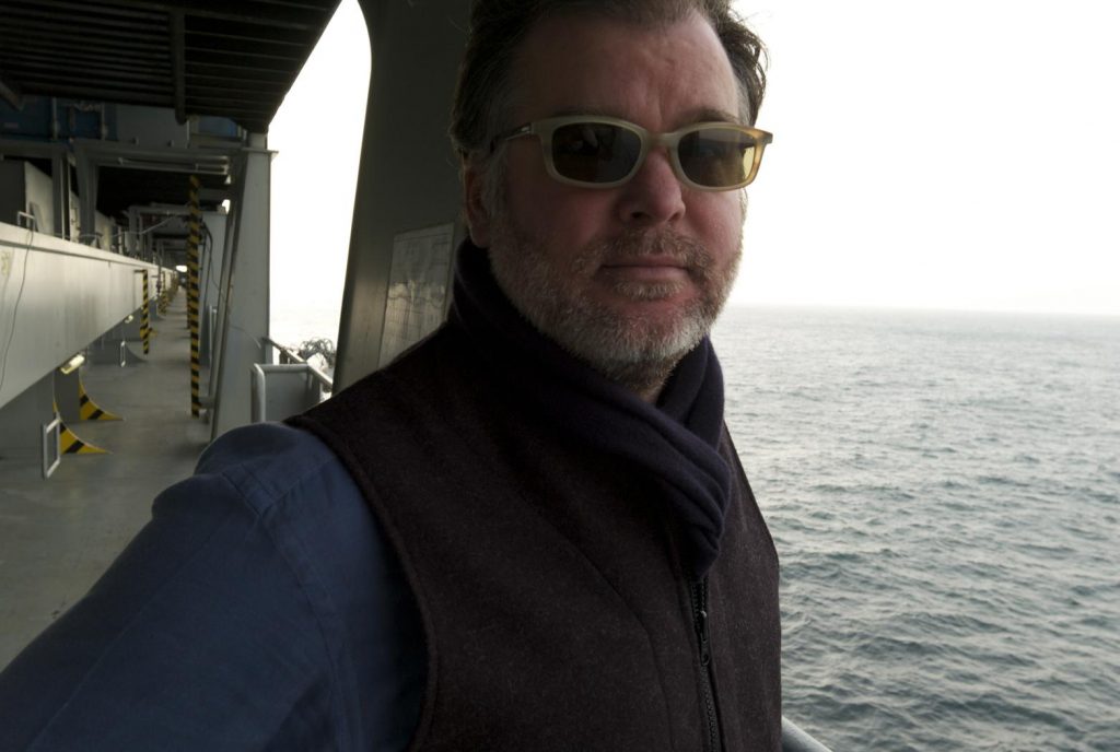 photo of Rob Long on the deck of a container ship at sea