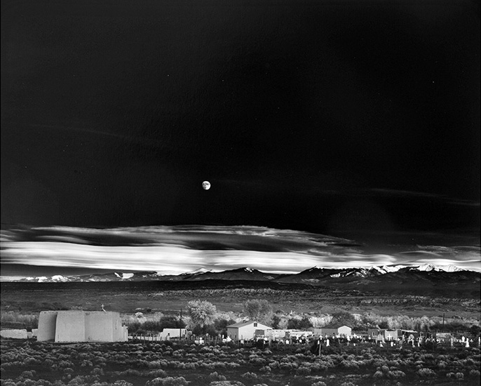 black and white photo of a moonrise