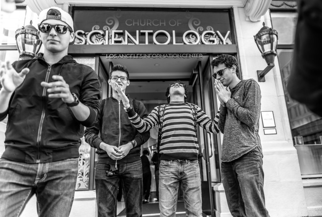 4 young guys "praying" in front of the Scientology Building on Sunset Blvd in Hollywood