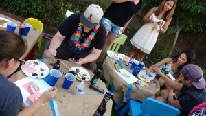 people painting at a backyard party