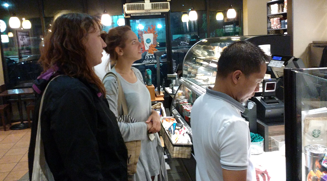 Marta & Sara looking at the menu at Starbucks