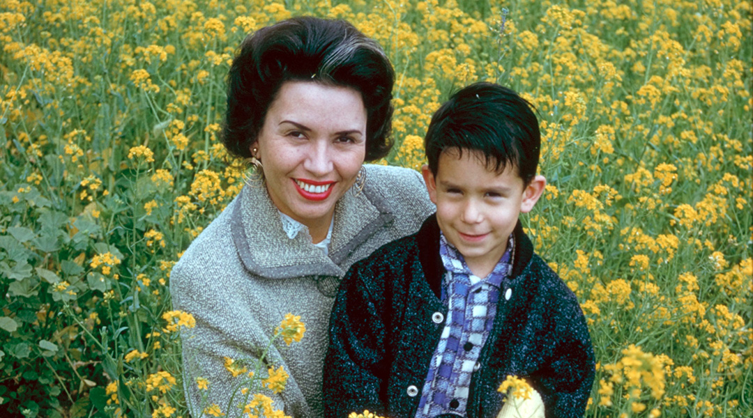 Vintage photo of Sheila and Glenn Zucman in a bright green and yellow field of mustard.