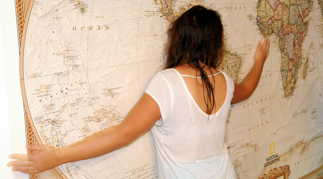 Elena "hugging" a 10-foot wide map of the world