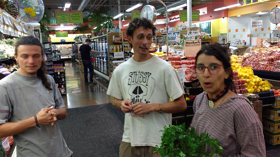 3 people discussing food choices at Mother's Market in Costa Mesa, CA