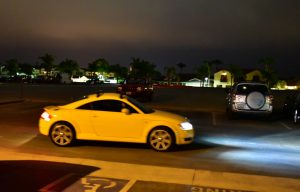 car driving through the Newport Aquatic Center parking lot at night