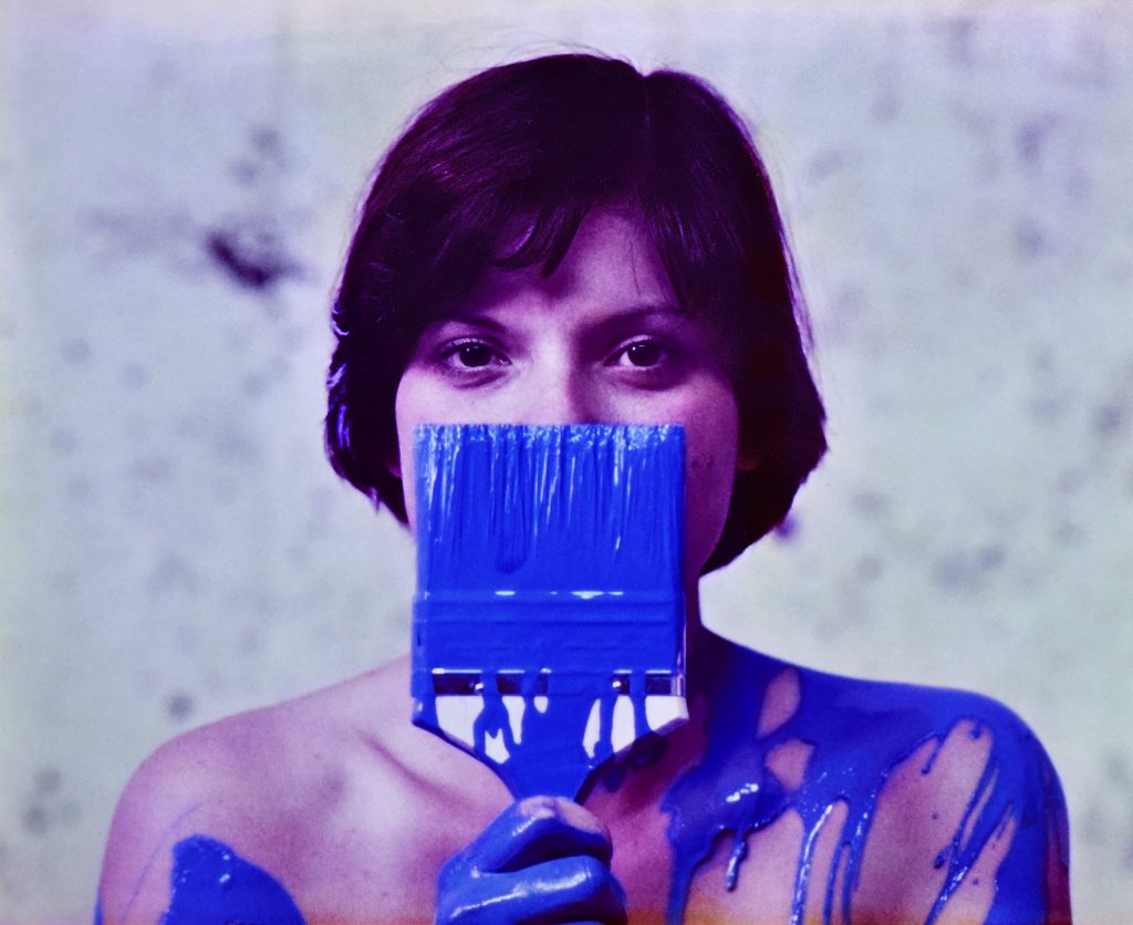 Photo of Christy Dant covered in blue paint, circa 1976