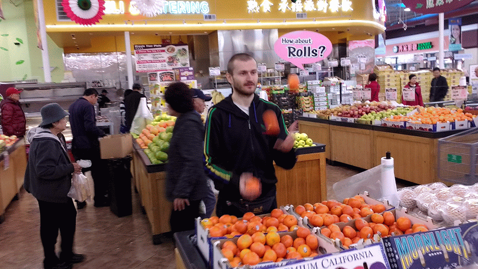 Animated GIF of Jacek juggling with fruits in the Asian Market in New Taipei, CA