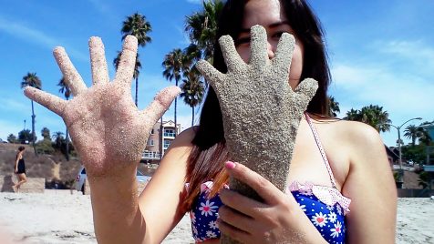 Betty Rodriguez comparing a plaster casting of her hand next to her outstretched hand