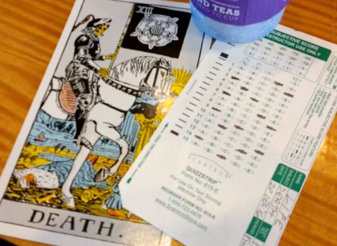 Card XIII, "Death" from the Rider-Waite-Smith Tarot deck, paired with a small Scantron form and a cup from Coffee Bean & Tea Leaf