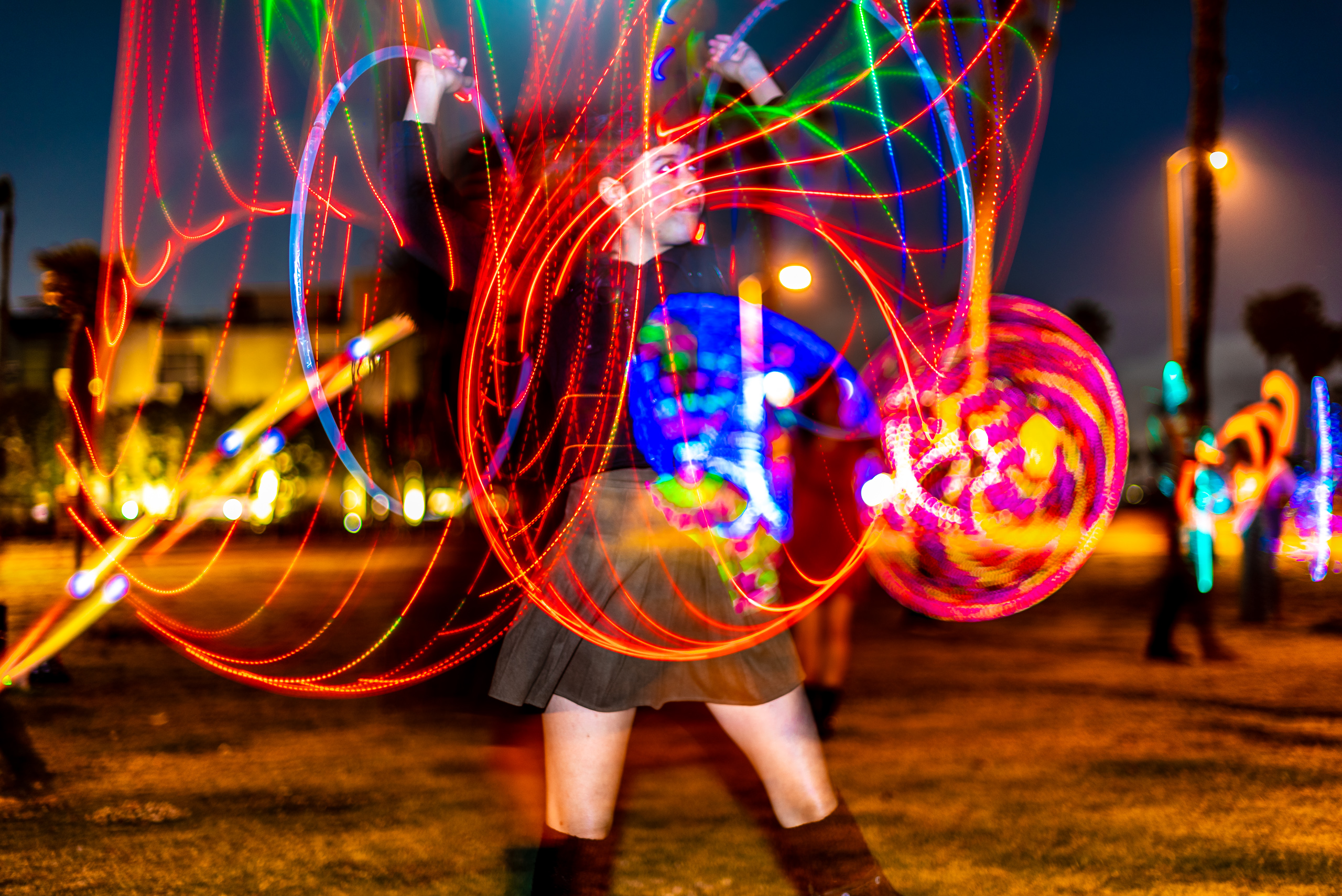 Sabrina Rodriguez, Sabrina “the Hoopist” Rodaisin, performing with an LED Hula Hoop at Venice Glow Flow's Wednesday night jam/class in the park in Venice Beach, CA