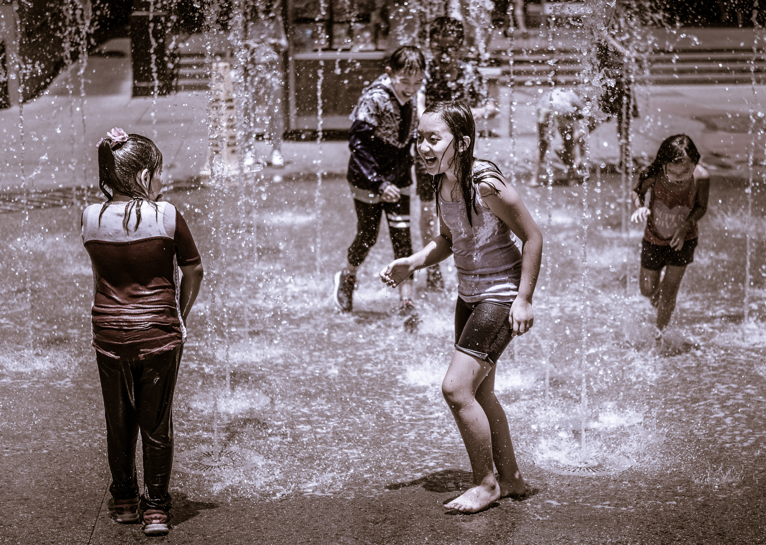 Kids joyously playing in the fountain at the Hollywood & Highland Center on a very hot, 100°F+ day in Los Angeles