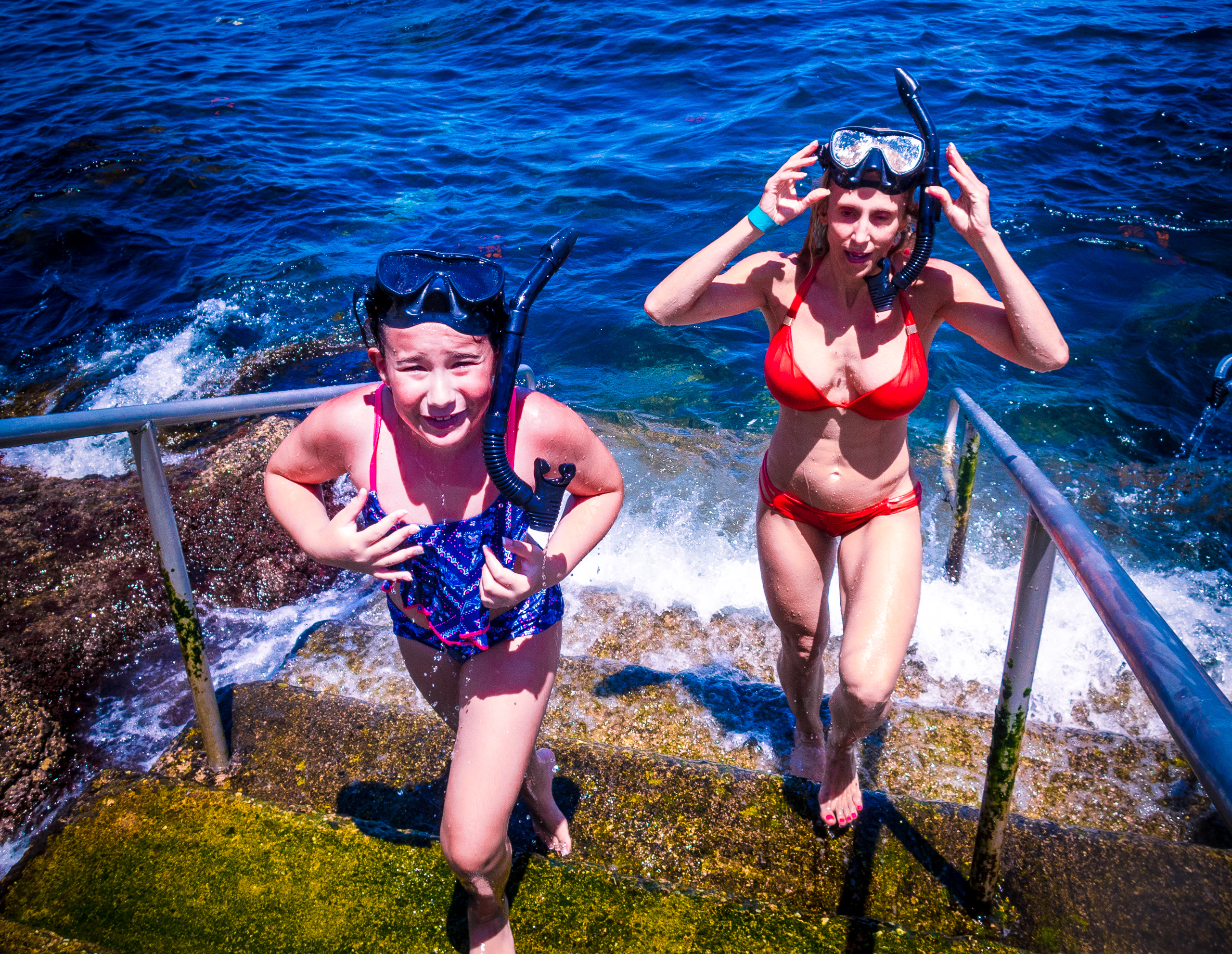 a family friend takes a young girl on her 1st snorkeling experience at the Casino Steps in Avalon, Catalina, Channel Islands, Los Angeles, California