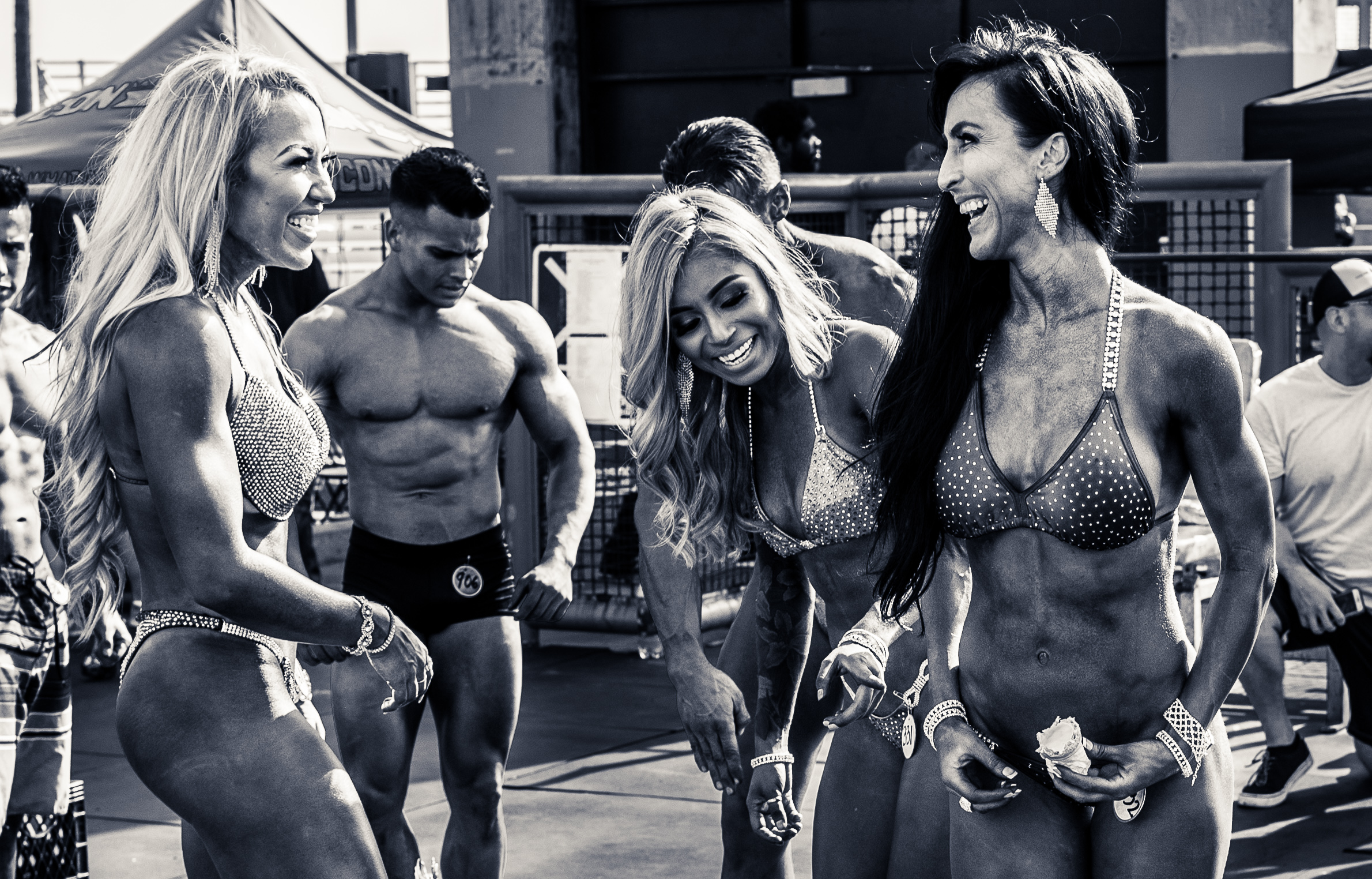 Jenni Stark, Adrianne Meese, and other competitors smiling & laughing after the Labor Day Muscle Beach Championship competition in Venice Beach, CA