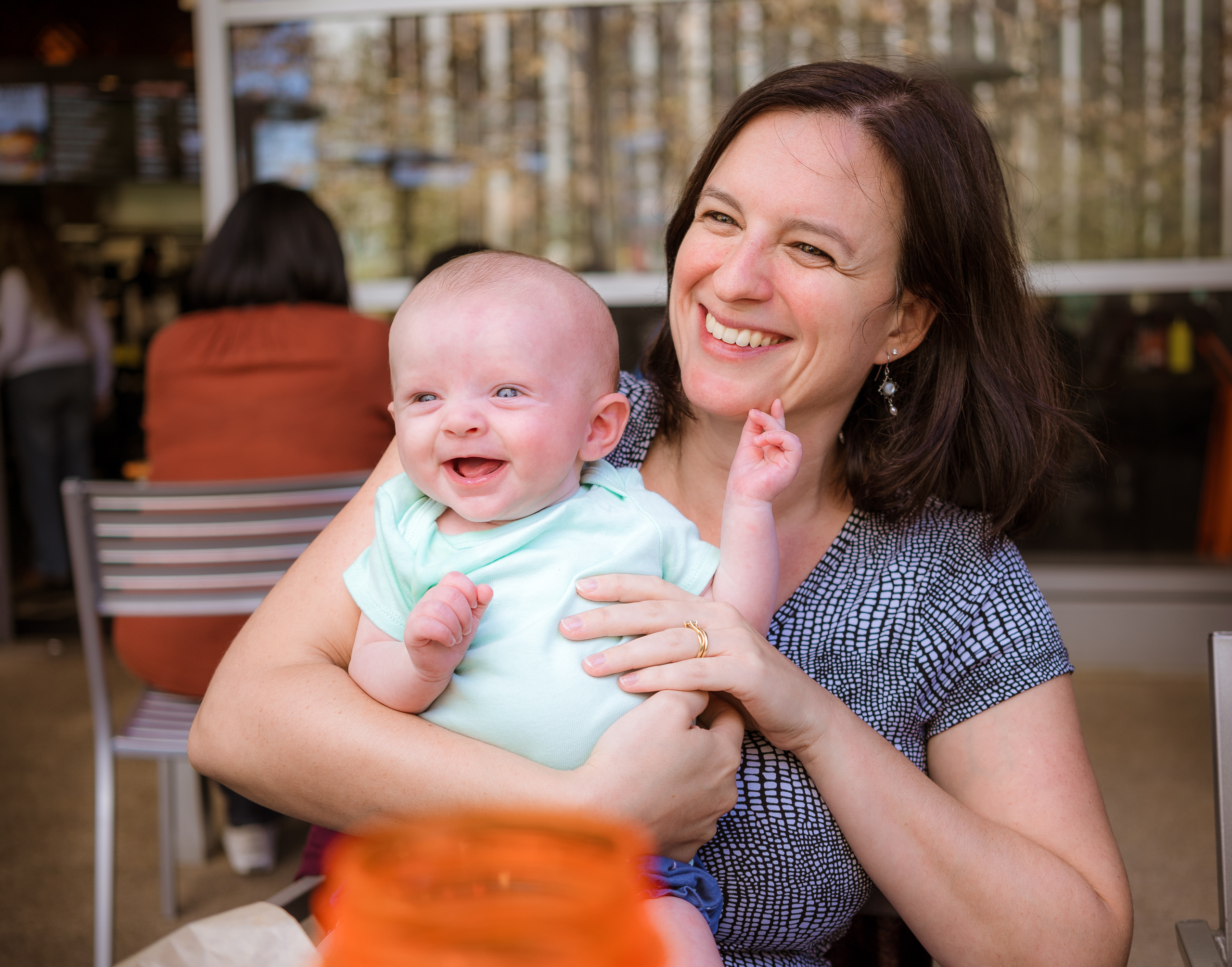 Los Angeles Photo Gang organizer Aurelia Dumont holds her new baby while having lunch in Century City, California