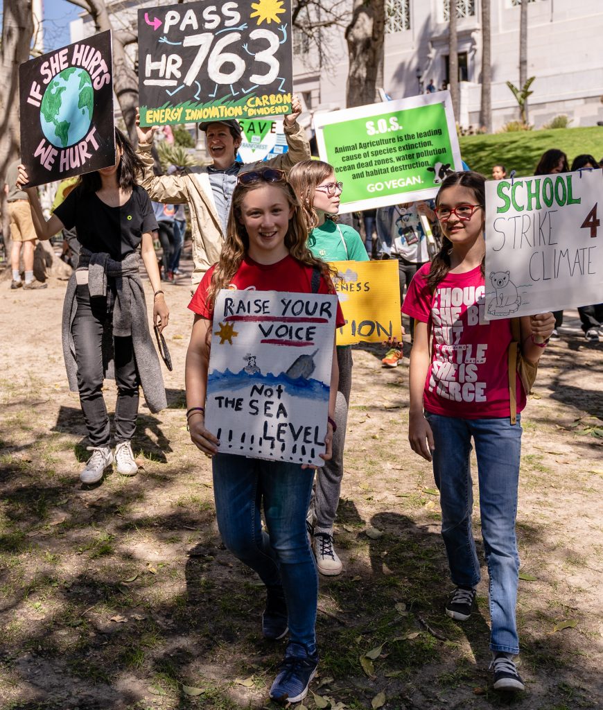Charlott Adelman, 13, from Girls Academic Leadership Academy (GALA) in Mid-City, Los Angeles, carries a "Raise your voice, not the sea level" sign in the Youth Climate Strike at Los Angeles City Hall on Friday, March 15, 2019. Adelman said, "We are here to tell politicians to stop climate change now before its effects are irreversible." "Fridays for the Future" is organized by 16-year-old Swede Greta Thunberg. The Los Angeles Youth Climate March is organized by 17-year-old Los Angeleño Arielle Martinez-Cohen. (Glenn Zucman/The Corsair)
