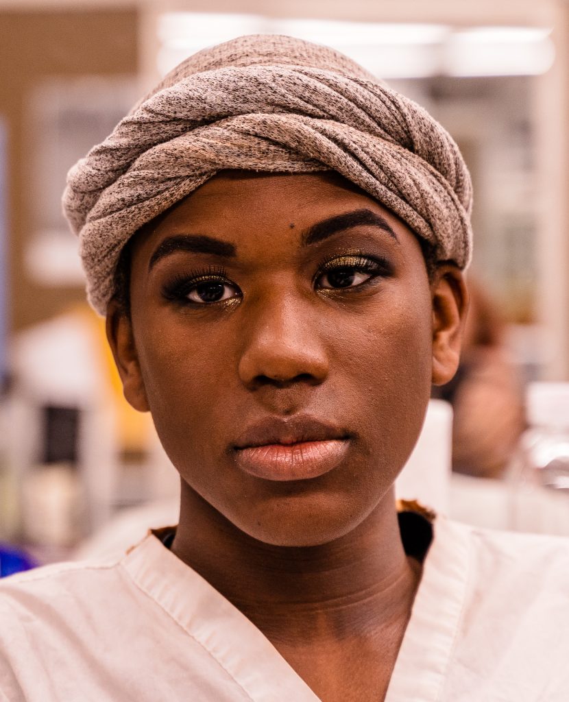 Skye Johnson, 18, A Brooklyn, NY Born, And Raleigh, NC Raised, Student In The SMC Esthetician Program In His Finished Makeup By Classmate Kaia Cobb At The SMC Cosmetology Salons In The Business Building On SMC’s Main Campus On Thursday, April 18, 2019. In Addition To The Esthetician Program, Johnson Is Also Taking His Nursing Prerequisites At SMC With The Goal Of Becoming A Medical Aesthetician. Medical Aestheticians Provide Skin Care In Medical Settings And Can Assist With Injectables Like Botox. (Glenn Zucman/The Corsair)