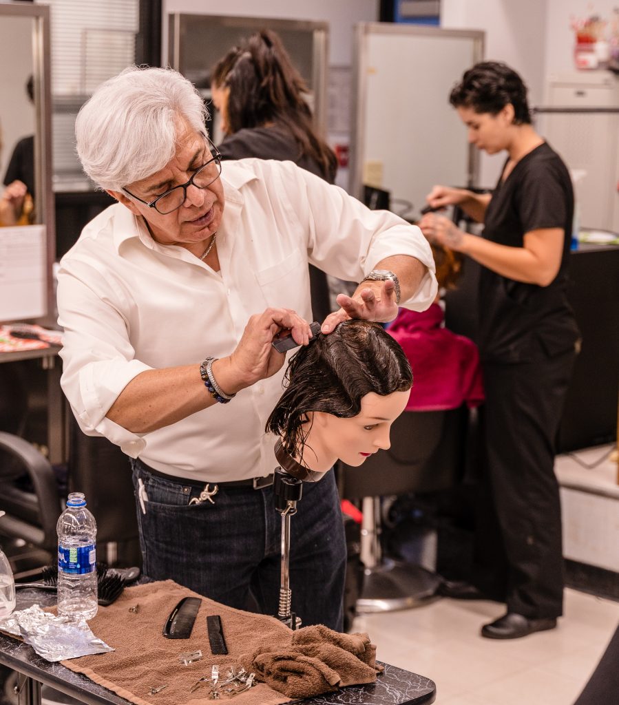 SMC Cosmetology Faculty Member Felipe Felix Demonstrating Hair Styling Techniques In The SMC Cosmetology Salon In The Business Building On Main Campus On Thursday, April 18, 2019. Felix Has Taught In The SMC Cosmetology Department Since 1989. (Glenn Zucman/The Corsair)