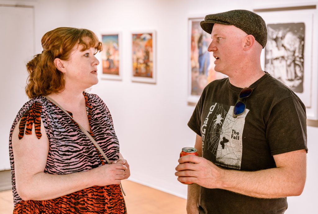 Artist Matthew Couper (Right) From New Zealand, And For The Last 9 Years, Las Vegas, Nevada, Talks With Fellow New Zealand Expat Jennifer Scott At The Opening Of His Solo Exhibition In Memory Of Water At La Luz De Jesus Gallery In Los Angeles On Friday, May 3, 2019. Two Shows Are Running At La Luz De Jesus From May 3 To June 2: Matthew Couper's Solo Exhibition In Memory Of Water, And The Group Portrait Show Onward Featuring Artists Michele Melcher, Baldur Helgason, Yeo Kaa, Valery Pobjoy, And Sung Jik Yang. (Glenn Zucman/The Corsair)