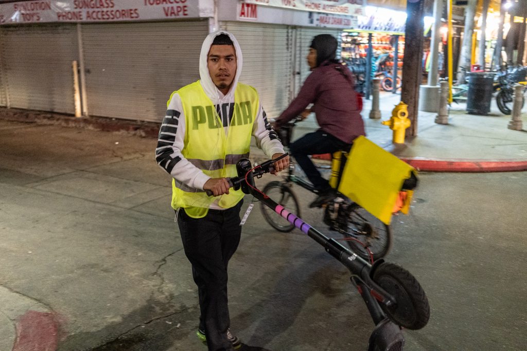 Lyft Employee Michael Jones, 19, From Los Angeles, Calif., Takes A Discharged Lyft EScooter From The Venice Beach Boardwalk To His Van On Thursday, Feb. 28, 2019. From There He'll Take The EScooter Back To The Lyft Warehouse Near The SMC Main Campus. At The Lyft Warehouse About 2,000 EScooters Are Charged And Repaired For Use Around Los Angeles. Jones Has Been Working For Lyft Since They Started EScooters In This Area In September 2018. (Glenn Zucman/The Corsair)