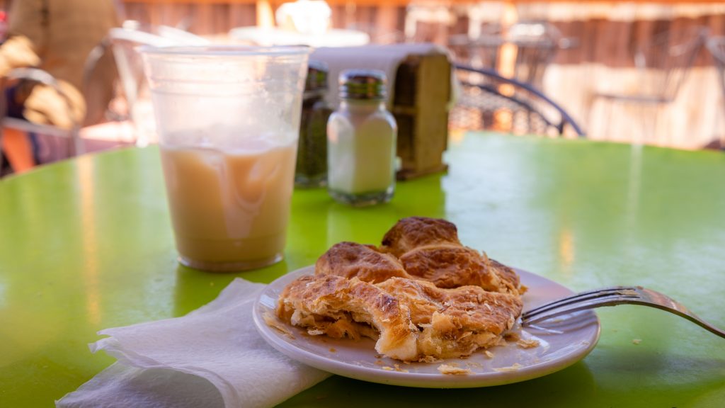 photo of an apple turnover and a iced chai drink.